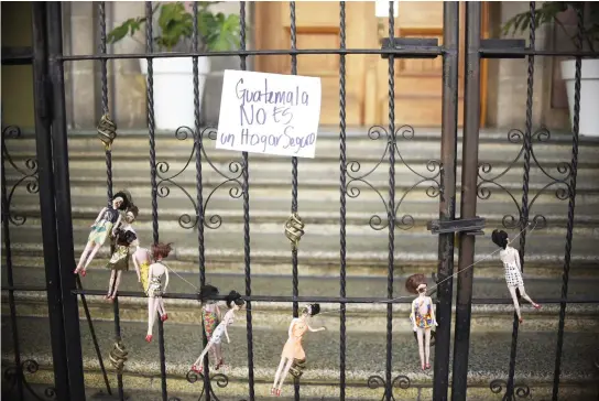 ??  ?? Dolls representi­ng the victims of a fire at the government-run children's shelter in San Jose Pinula, east of Guatemala City, are seen on the gate of the presidenti­al house on Thursday. (AFP)
