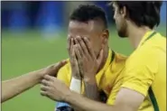  ?? LEO CORREA — THE ASSOCIATED PRESS ?? Brazi’s Neymar covers his face with his hands as he celebrates after scoring the decisive penalty kick during the final match of the mens’s Olympic football tournament between Brazil and Germany at the Maracana stadium in Rio de Janeiro, Brazil,...