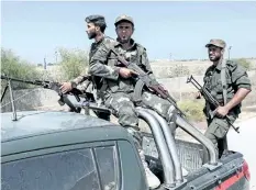  ?? SAID KHATIB/GETTY IMAGES ?? Hamas security forces ride in the back of a pickup truck as they patrol an area along the border with Egypt. Yehiyeh Sinwar, the leader of Hamas, says Iran has restored relations with the terror group.