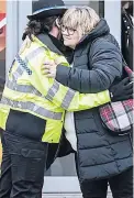  ??  ?? SUPPORT Mum Lisa hugs officer
