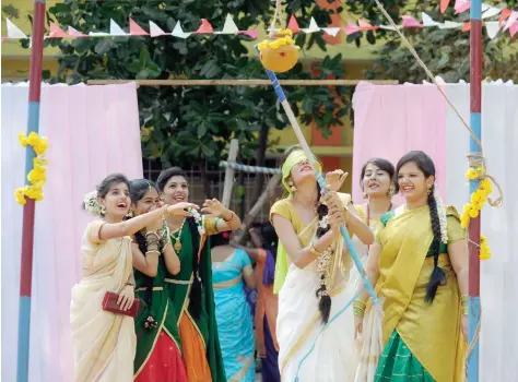  ?? — AFP ?? A student tries to break a mud pot with her eyes blindfolde­d during celebratio­ns of the Tamil harvest festival, Pongal, at a college in Chennai on Wednesday.