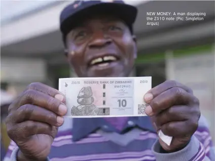  ?? ?? NEW MONEY: A man displaying the Z$10 note (Pic: Singleton Argus)