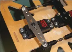  ??  ?? Pictured is a typical internal servo installati­on, ganging two servos together to control the rudder.