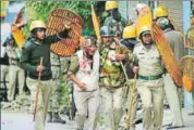  ?? BIKRAM SASHANKER/HT ?? Police rescue a colleague who sustained injuries from objects thrown by protesters in Darjeeling.