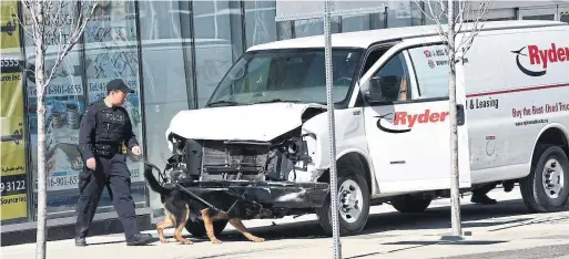  ?? DAN PEARCE/METROLAND ?? A K-9 unit examines a Ryder rental van on Yonge St. on Monday. The van was owned by a company in Concord. The firm expressed its sympathies to those affected.