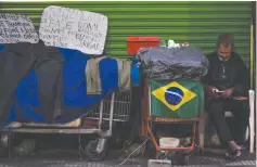  ?? (Nelson Almeida/AFP/Getty/TNS) ?? A HOMELESS man is seen in a street of Sao Paulo.