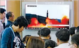  ?? AHN YOUNG-JOON/AP ?? South Koreans in Seoul watch a news program Sunday showing a file image of a North Korean missile launch. The new launch presents a challenge to South Korea’s new leader.