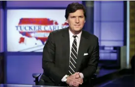  ?? RICHARD DREW— THE ASSOCIATED PRESS FILE ?? In this file photo, Tucker Carlson, host of “Tucker Carlson Tonight,” poses for photos in a Fox News Channel studio, in New York.