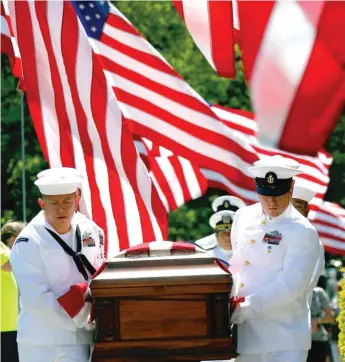  ?? BRIAN HILL/ DAILYHERAL­D ?? Members of the Great Lakes Honor Guard carry the casket containing the remains ofWalter H. Backman, who was among those killed aboard the USS Oklahoma when the Japanese attacked Pearl Harbor on Dec. 7, 1941. His remains were finally laid to rest Monday...