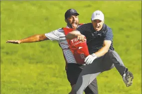  ?? Maddie Meyer / Getty Images ?? Jordan Spieth celebrates with caddie Michael Greller after chipping in for birdie from a bunker on the 18th hole to win the 2017 Travelers Championsh­ip.