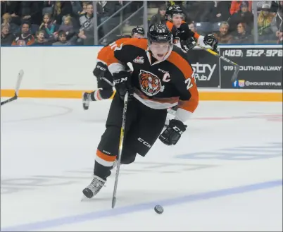  ?? NEWS PHOTO RYAN MCCRACKEN ?? Medicine Hat Tigers captain Mark Rassell carries the puck through the neutral zone during a Western Hockey League game against the Lethbridge Hurricanes on Sept. 23 at the Canalta Centre. The Tigers will play the Everett Silvertips Wednesday at 7 p.m....