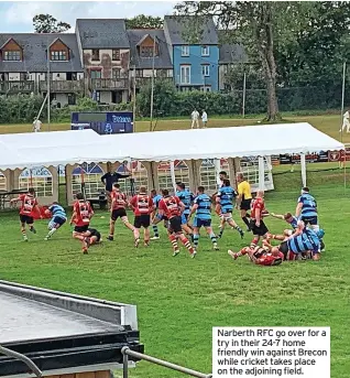 ?? ?? Narberth RFC go over for a try in their 24-7 home friendly win against Brecon while cricket takes place on the adjoining field.