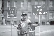  ?? THE ASSOCIATED PRESS ?? Anti-Brexit, pro-EU supporter Steve Bray holds placards on Abingdon Green across the road from the Houses of Parliament in London on Monday. Former U.K. Brexit Secretary David Davis said Monday that he won’t seek to challenge Prime Minister Theresa...