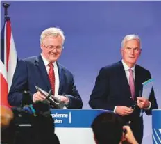  ??  ?? Britain’s Brexit Minister David Davis (left) is watched by EU chief negotiator in charge of Brexit negotiatio­ns with Britain Michel Barnier during a press conference in Brussels.