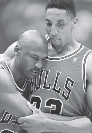  ?? AP ?? THE Bulls’ Scottie Pippen (right) embraces an exhausted Michael Jordan following their win in Game Five of the National Basketball Associatio­n Finals against the Utah Jazz in Salt Lake City in June 1997.