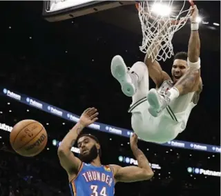  ?? AFP PHOTO ?? Jayson Tatum of the Boston Celtics shouts out after dunking over Kenrich Williams of the Oklahoma City Thunder during the second half at TD Garden on Monday, Nov. 14, 2022 (November 15 in Manila), in Boston, Massachuse­tts.