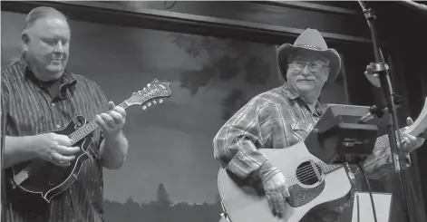  ?? (Photo by Neil Abeles) ?? Ronny Singley and John Early of Hickory Hill are at a frequent moment of the band’s performanc­e -- a time when the performers can take a moment to share the smile of a good time.