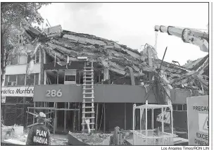  ?? Los Angeles Times/RON LIN ?? The upper stories at this Mexico City office building collapsed like pancakes in the earthquake that struck the region in late September.