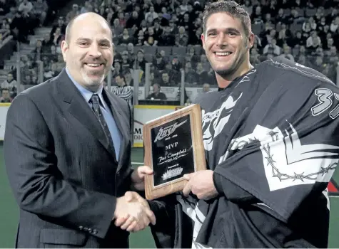  ?? FILE PHOTO ?? One-time St. Catharines Athletics coach Paul Day, shown presenting goaltender Pat Campbell with the team's most valuable player award in his capacity as Edmonton Rush head coach in this March 2006 file photo, will be inducted into the Ontario Lacrosse...