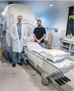  ??  ?? Dr. Shane Greek, left, and technician Yves Gagnon with the MRI machine at the Royal Jubilee Hospital. The province said that 188,000 MRI exams were slated to be performed this year at hospitals and clinics in the public system. New funding will allow...