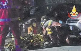  ?? The Associated Press ?? Rescuers aid injured people outside a nightclub Saturday in Corinaldo, Italy.