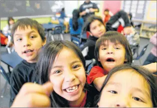 ?? CP PHOTO ?? In this file photo, Grade 2 students are excited to have their photo taken at the Eenchokay Birchstick School on the Pikangikum First Nation. Pikangikum First Nation is a remote-access community located on Pikangikum Lake, approximat­ely 100 km...