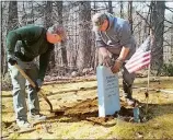  ?? COURTESY OF THE TOWN OF PLAINFIELD, N.H. ?? Workers install Derrick Oxford’s new headstone, which was supplied by the Department of Veteran Affairs.