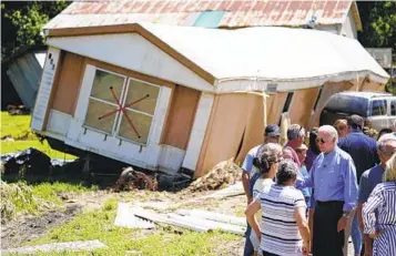  ?? EVAN VUCCI AP ?? On Monday, President Joe Biden tours a neighborho­od in Lost Creek, Ky., impacted by severe flooding.