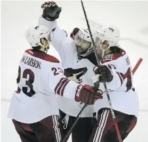  ?? GARY WIEPERT/THE ASSOCIATED PRESS ?? To the cheers of Buffalo fans, Arizona’s Oliver Ekman-Larsson, left, Sam Gagner, centre, and John Moore celebrate Gagner’s overtime winning goal against the Sabres Thursday.