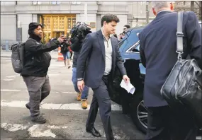  ?? Julie Jacobson / Associated Press ?? Gordon Caplan, of Greenwich, center, walks out of federal court in New York City on Tuesday. Fifty people, including Hollywood stars Felicity Huffman and Lori Loughlin, were charged in a admissions bribery scheme.
