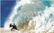  ?? Jerrett Lau via AP ?? Clark Little photograph­s waves on the North Shore of Oahu near Haleiwa, Hawaii.