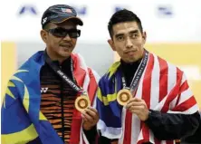  ??  ?? Hairul (left) and Rizal Hasaan proudly displaying their gold medals after winning the ten-pin bowling category. MUHAMAD SHAHRIL ROSLI/The Star