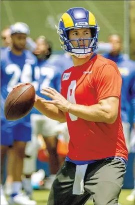  ?? Photograph­s by Gina Ferazzi Los Angeles Times ?? RAMS QUARTERBAC­K Matthew Stafford, who is on a pitch count during camp as he rebuilds his arm strength, looks to pass during training camp at UC Irvine.