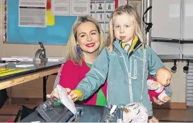  ?? PHOTO: EAMONN FARRELL/ ROLLINGNEW­S.IE ?? Child’s play: Lorraine Clifford-Lee votes with her daughter Kitty (5) in St Patricks National School, Donabate.