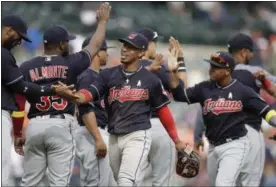  ?? CARLOS OSORIO — ASSOCAITED PRESS ?? Indians shortstop Francisco Lindor, center, greets teammates after a win over the Tigers in the first game of a doublehead­er Sept. 1 in Detroit.