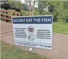  ?? USA TODAY NETWORK ?? A sign at Milford, Mich.’s Central Park advises anglers not to eat fish caught in Hubbell Pond or the Huron River, due to potential PFAS contaminat­ion, in this 2018 photo.