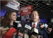  ?? PHELAN M. EBENHACK — THE ASSOCIATED PRESS ?? Florida Governor-elect Ron DeSantis, right, answers questions from reporters, with his wife Casey, after being declared the winner of the Florida gubernator­ial race at an election party Tuesday in Orlando, Fla.