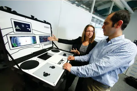  ?? (Ralph Orlowski/Reuters) ?? ALEXANDRA SCHAEFER, head of the SmartCore-Center of Competence, and her colleague Hector Zarate of US automotive supplier Visteon work on a setup to demonstrat­e their new ‘SmartCore’ dashboard at the company’s technical center in Karlsruhe, Germany,...