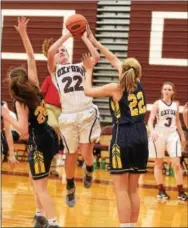  ?? PETE BANNAN — DIGITAL FIRST MEDIA ?? Oxford leading scorer Miranda Porretta shoots over Unionville defenders Sarah Covert (20) and Grace Schrof