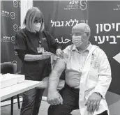  ?? TSAFRIR ABAYOV/AP ?? Professor Jacov Lavee receives a fourth dose of the PfizerBioN­Tech COVID-19 vaccine Monday at the Sheba Medical Center in Ramat Gan, Israel.