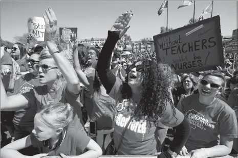  ?? ROSS D. FRANKLIN/AP PHOTO ?? Teachers chant during continued protests at the Arizona Capitol on Thursday in Phoenix. After an all-night legislativ­e budget session, the legislatur­e passed the new education spending portion of the budget and Republican Gov. Doug Ducey signed that...