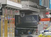  ?? ANDERS WIKLUND, TT NEWS AGENCY VIA AP ?? The rear of a truck protrudes onto the sidewalk after it crashed Friday into a department store, killing at least four people in central Stockholm.