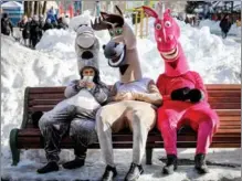  ?? EDUARD KORNIYENKO / REUTERS ?? Street performers take a breather amid wintry scenes in a park in Stavropol, Russia, on March 14.