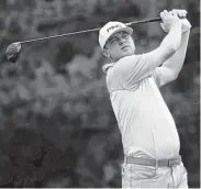  ?? Gregory Shamus / Getty Images ?? Nate Lashley plays his shot from the fourth tee during round two of the Rocket Mortgage Classic at the Detroit Country Club on Friday.