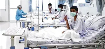  ?? ASSOCIATED PRESS ?? In this image made from video and released by the Thailand Government Spokesman Bureau, three of the 12 boys are seen recovering in their hospital beds after being rescued along with their coach from a flooded cave.