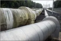  ?? THE ASSOCIATED PRESS ?? Pipes carrying liquified natural gas to and from a holding tank, background, at Dominion Energy’s Cove Point LNG Terminal in Lusby, Md.