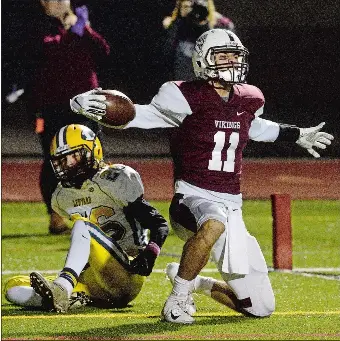  ?? DANA JENSEN/THE DAY ?? East Lyme’s Shawn Soja (11) celebrates after catching a touchdown pass from Chris Salemme in front of Ledyard’s Matt Thornton during the Vikings’ 42-12 win over Ledyard on Friday night.