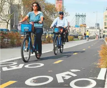  ?? AFP ?? People cycle from the Brooklyn Bridge. New York is making considerab­le progress in encouragin­g pedal power at the expense of exhaust fumes.