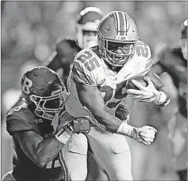  ?? [ADAM CAIRNS/DISPATCH] ?? Mike Weber, trying to break free of Rutgers’ Trevor Morris, ran for three touchdowns in the victory.