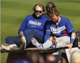  ?? K.C. ALFRED — THE SAN DIEGO UNION-TRIBUNE ?? The Dodgers' Gavin Lux is carted off the field after getting injured running to third base against the Padres during a spring training game on Monday.